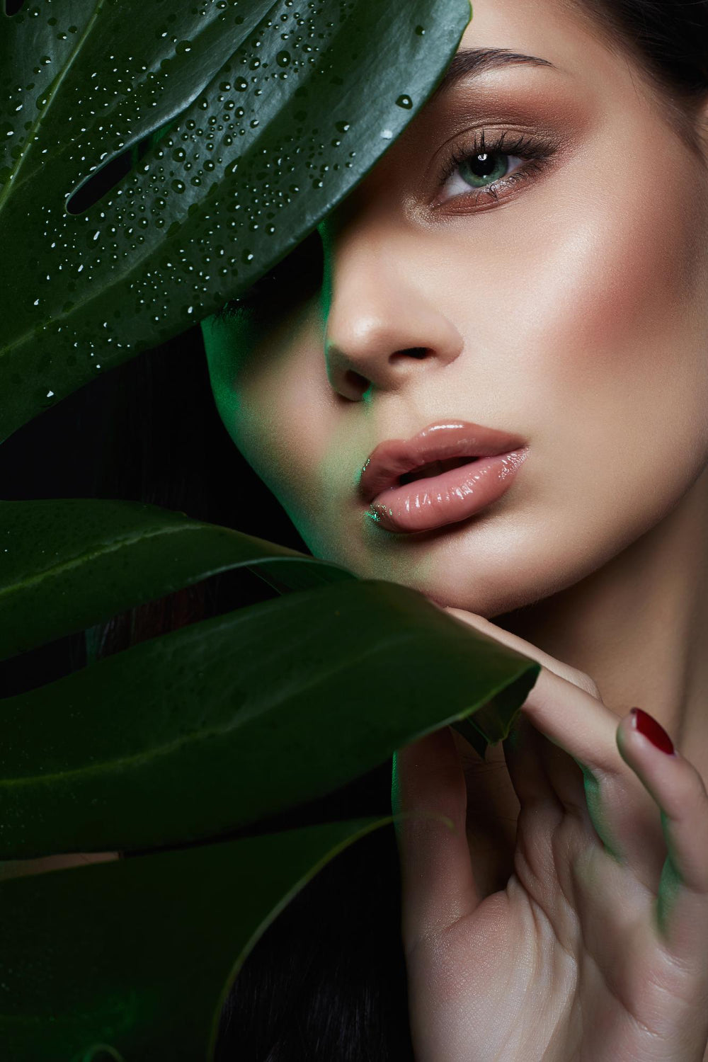 Woman's face with a leaf, close-up
